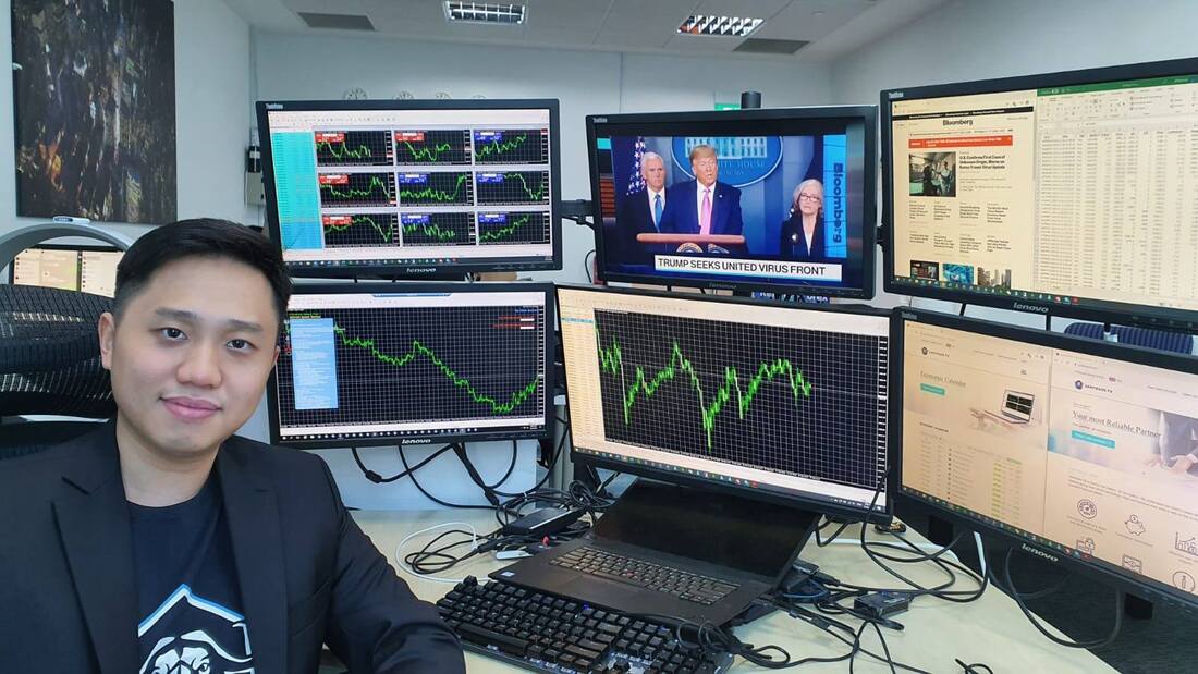 Rieve Ko at his multi-screen trading desk monitoring live XAUUSD charts and financial news